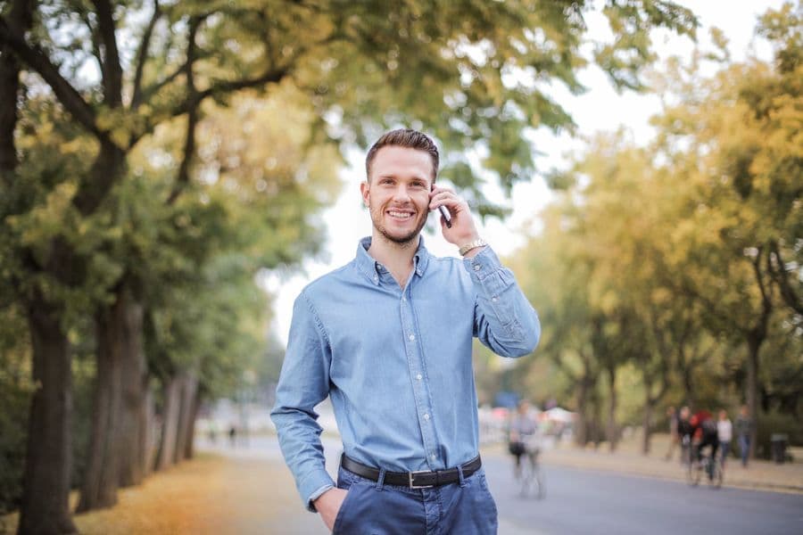 A man on the phone walking through a park